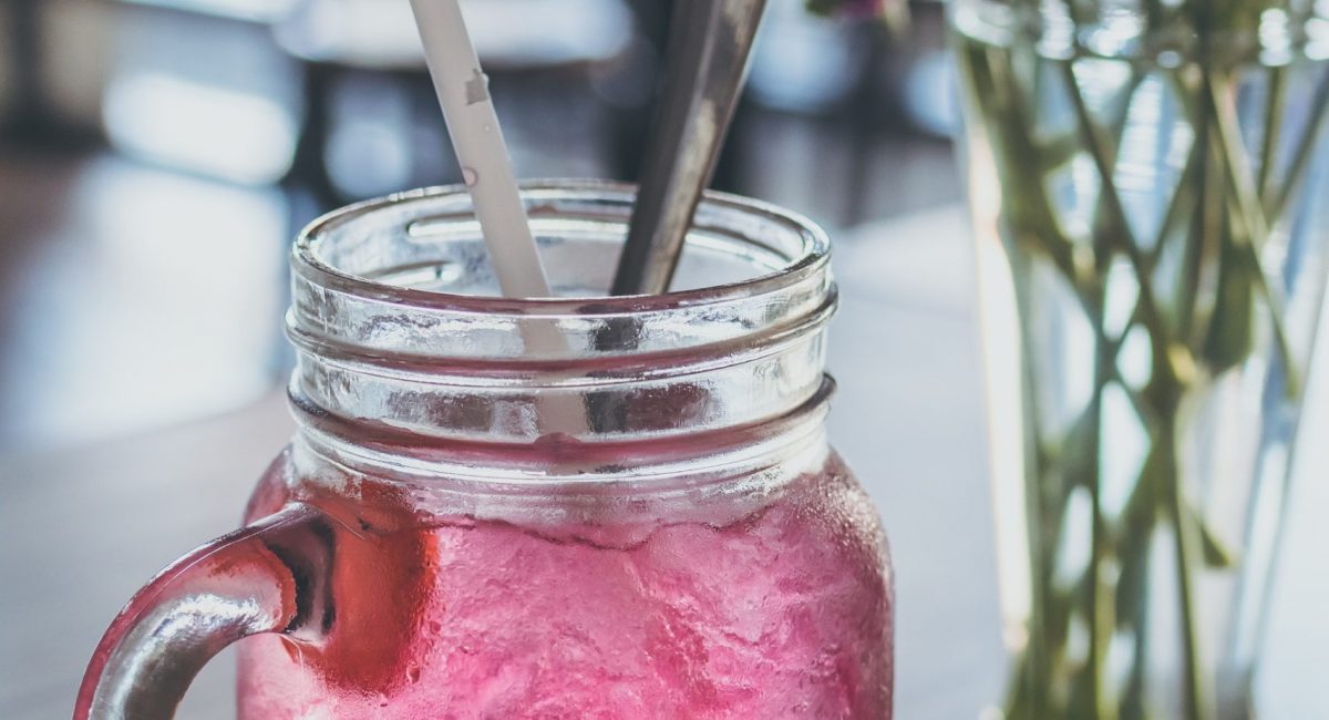 red-beverage-filled-clear-glass-mason-mug-with-straw-beside-914241-2-scaled